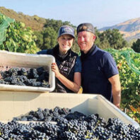 Samantha Hege and Colton Smith with the last tub going into a 2020 Petite Sirah from Cocavin Vineyards in Paso Robles.