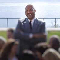 James Donaldson stands in a park in front of ocean