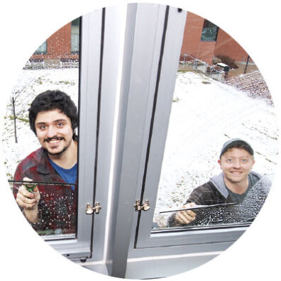 John Jane and Zac Howell washing windows at Washington State University Pullman