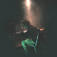 Computer hacker in a dimly lit room