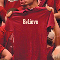 WSU student holds a t-shirt that reads Believe