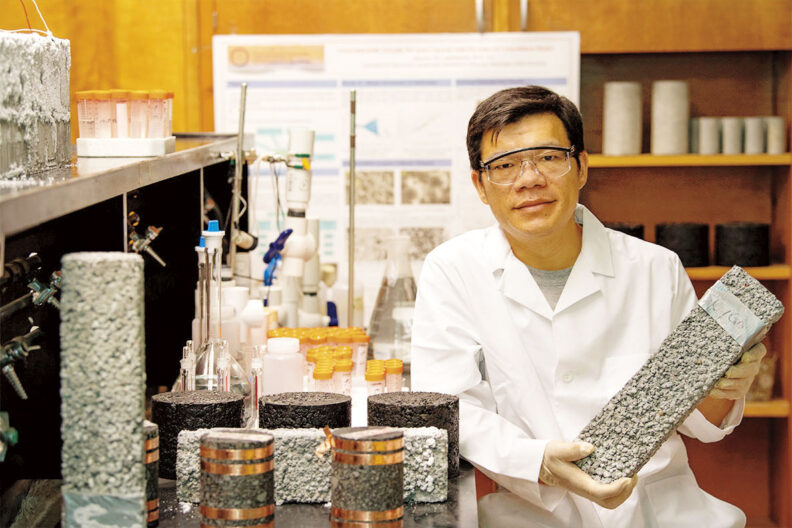 Xianming Shi at Washington State University holds concrete sample in his lab