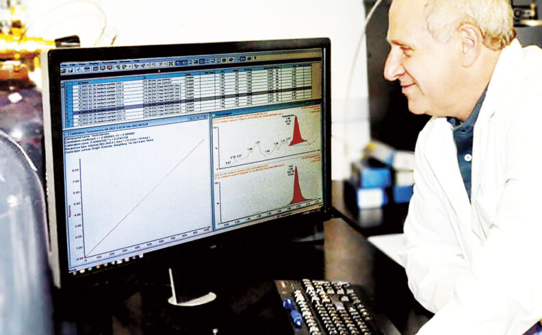 Washington State University pharmacy professor Philip Lazarus looks at charts on a computer