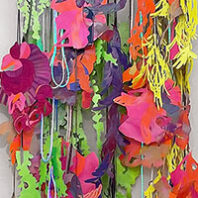 Colorful multimedia art hangs on wall