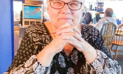 Karen Troianello sits in a cafe