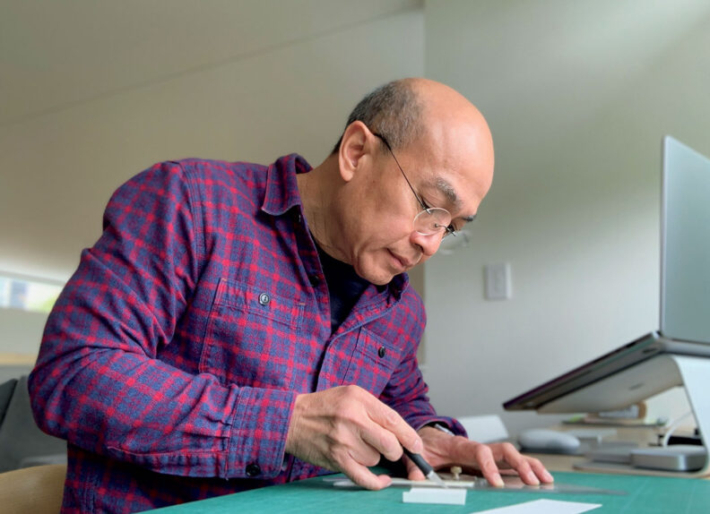 Architect Chris Chin draws at his desk