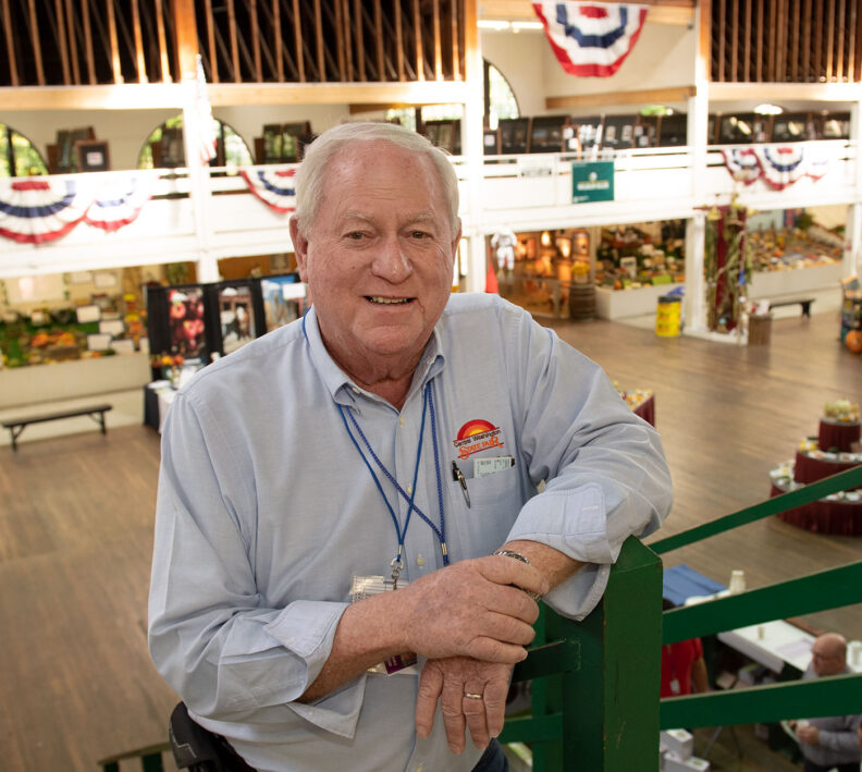 Greg Stewart stand above exhibits at fair