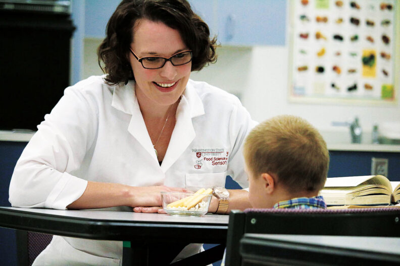 WSU food science professor Carolyn Ross with her son testing food textures