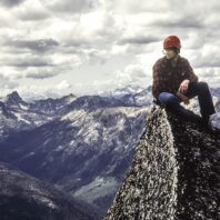 Mark Strother sits on a mountain summit in 1982