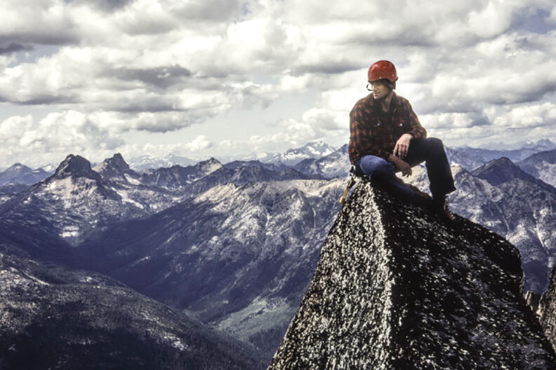 Mark Strother sits on a mountain summit in 1982
