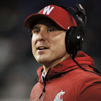 WSU head football coach Jake Dickert wearing W hat and headset