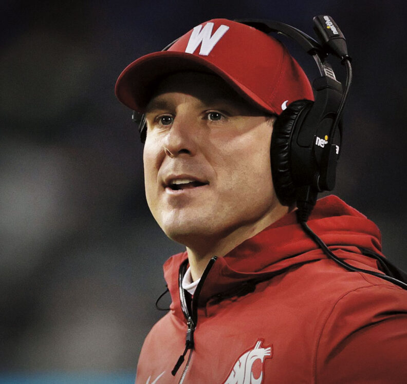 WSU head football coach Jake Dickert wearing W hat and headset