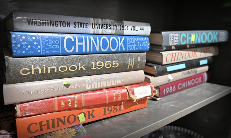 Stack of old WSU Chinook yearbooks at WSU Surplus
