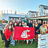 First-gen Abroad students in Spain hold a WSU Cougar flag