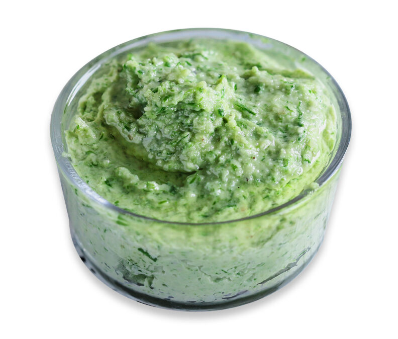 glass bowl of green garlic scape pesto