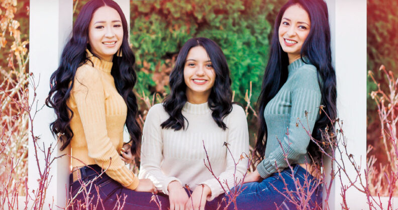 Sisters Anjelica Reyna Mora, Samantha Reyna, and Lourdes Reyna Alcala sit in a gazebo
