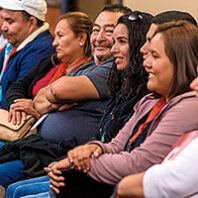 A group of people sitting at Washington State University's Spanish language orientation