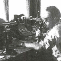 Dick Fry with radio equipment in black and white photo