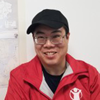 Wayne Chang profile wearing cap and red jacket