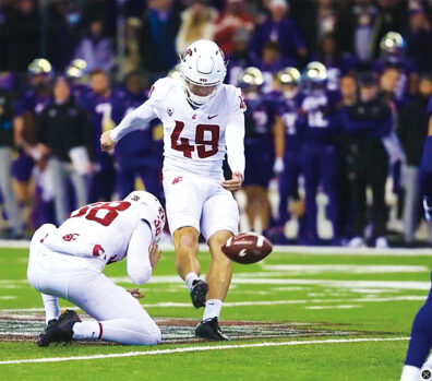 Dean Janikowski kicks football in a field goal attempt
