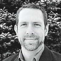 headshot of Chris Duke in black and white