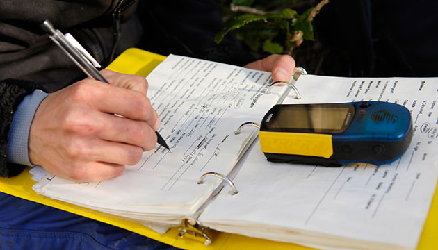 Tools of the wildlife biologist's trade: a waterproof notebook, a reliable pen, and a GPS unit.