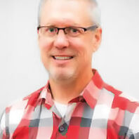 Profile of Greg Selstead in a flannel shirt