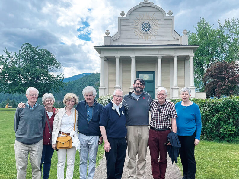 A group of people stand in front of Cataldo Mission
