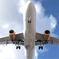 The bottom of a flying jet plane going overhead