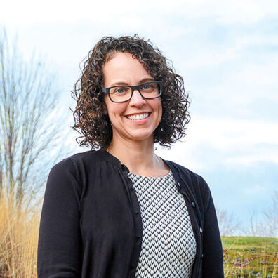 Profile of Elizabeth Weybright outside with a tree and field in background