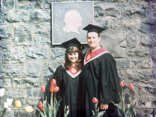 Woman and man in graduation robes at WSU