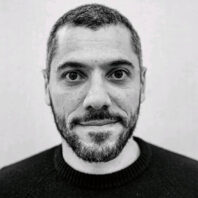 Black and white profile shot of Omar Al-Hassawi