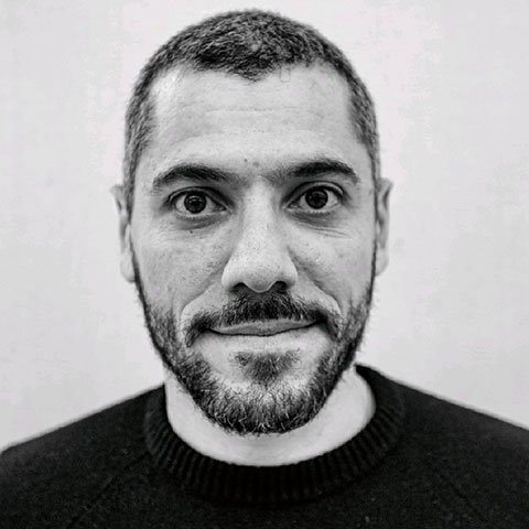 Black and white profile shot of Omar Al-Hassawi