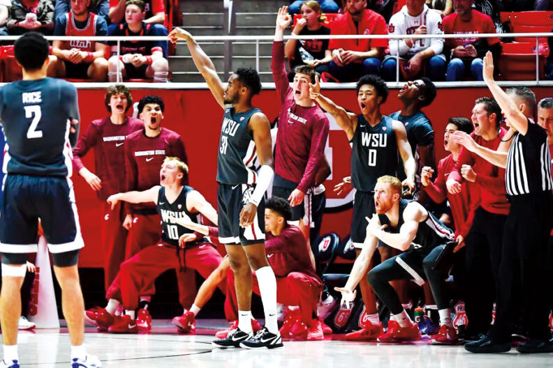 WSU mens basketball team members celebrate at a basketball game