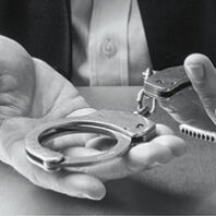Hand holds handcuffs