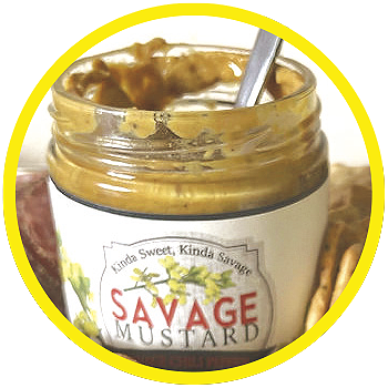 Open jar of mustard with a spoon in it