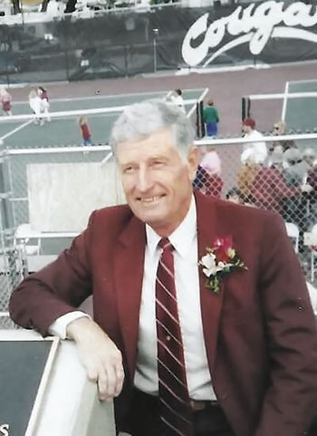 Rex Davis sits in front of WSU tennis courts