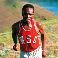 Man runs up a hill above a river