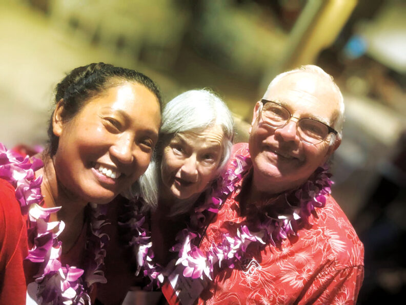 three people with lei