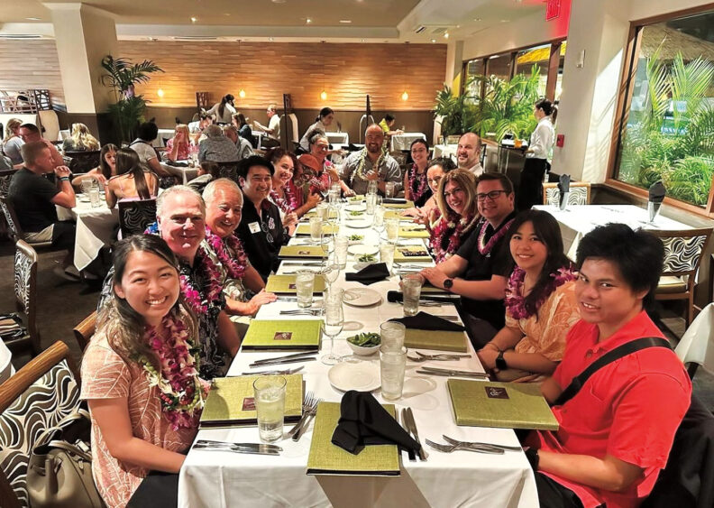 A group of people around a long table in a restaurant