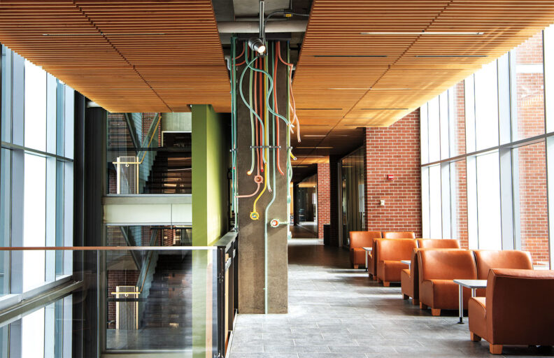 Colorful tubes go down a concrete pillar in an art installation