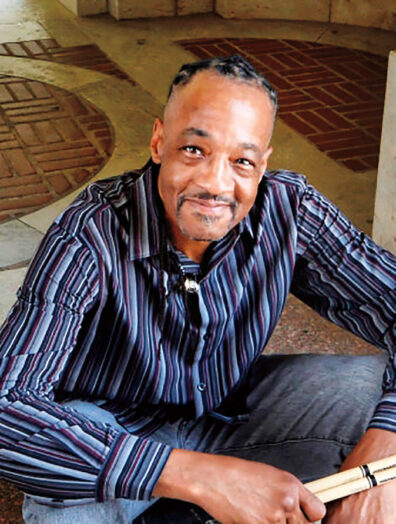 Darryl Singleton sits on a step in a building