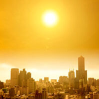 sun over a city skyline