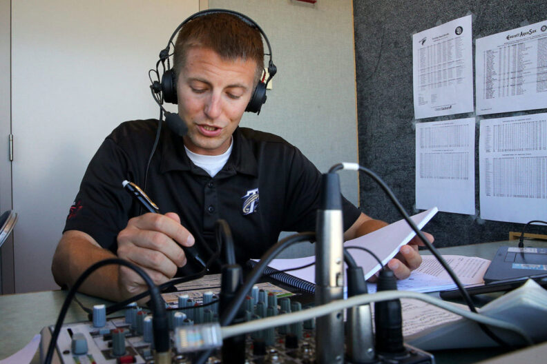 A young man in headphones doing sports announcing