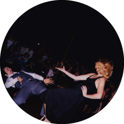 A WSU man bends backward at a disco while his female partner holds out her hand