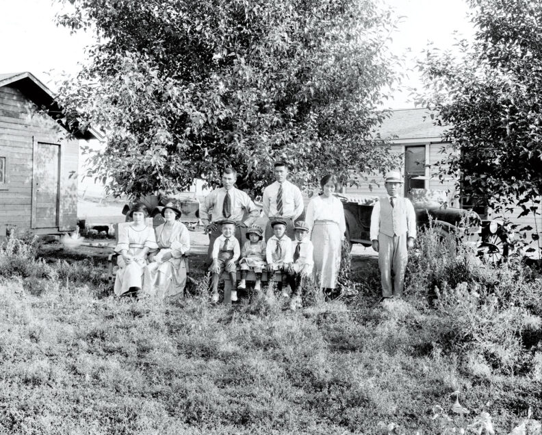 A black and white Japanese American family photo from early 20th century at a farm in central Washington