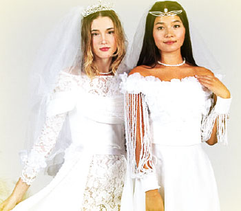 Two women model white wedding dresses