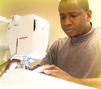 A student using a sewing machine to make clothes