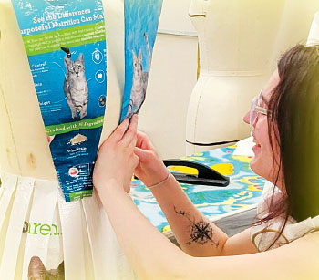A student puts together a dress from discarded kitty litter bags.