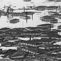 black and white photo of houses in a flood